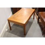 A Parker Knoll teak low coffee table, on moulded supports, 20" x 36"