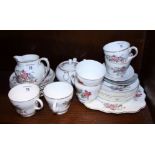A Wedgwood bone china teaset, painted with insects and floral sprays, and a complete set of