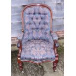 A Victorian mahogany showframe scroll open armchair, button upholstered in a floral tapestry, on