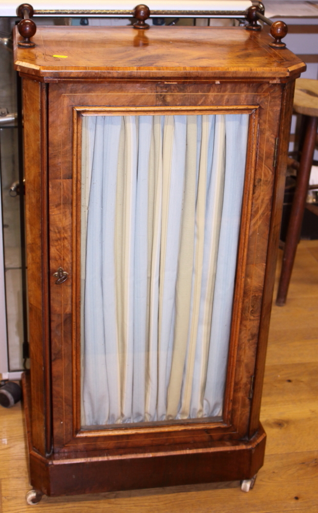 A Victorian figured walnut, inlaid and kingwood banded music cabinet with brass rail gallery over