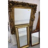 An ornate gilt framed wall mirror, another gilt framed wall mirror, a mahogany framed mirror