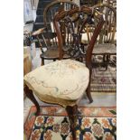 A Victorian carved walnut loop back side chair