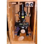 A Spencer Buffalo USA microscope and accessories, in fitted wooden case