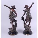 A pair of spelter figures, "Message" a woman releasing a bird, and "Souvenir" a woman with a