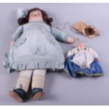 An Armand Marseille bisque headed doll, No 370, with go to sleep eyes, 20" long, and a souvenir doll