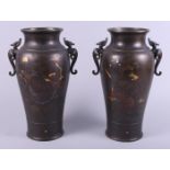 A pair of 19th century bronze and mixed metal inlaid vases with dragon handles and bird