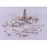 A silver sifter with pierced decoration, on octagonal base, four silver napkin rings, a pair of