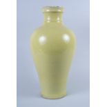 A Chinese Kangxi porcelain yellow monochrome baluster vase with crackle glaze and ribbed outswept