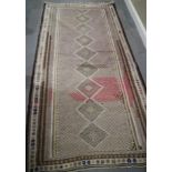 A Kazak kelim rug with eight half diamond guls and multi-borders, 94" x 50" approx