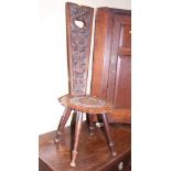 A carved oak spinning stool with dolphin and acanthus decoration, on turned supports