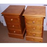 A pair of pine bedside chests of three drawers, on block bases, 16" wide