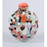 A Chinese porcelain snuff bottle, decorated numerous immortals in high relief, seal mark to base,