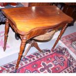 A 19th century mahogany serpentine top fold-over tea table, on turned and castored supports, 36"
