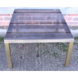 A glass topped coffee table and an upholstered foot stool