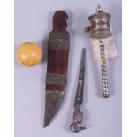 A white metal and stone mounted prayer wheel, a silver plated RMS Oronsay letter opener, a composite