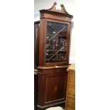 A late 19th century mahogany and line inlaid corner cabinet, the upper section enclosed astragal