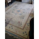 A modern flat weave rug with floral design on a cream ground, 120" x 112" approx