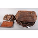 A 1930s crocodile skin clutch bag and two Gladstone type bags, one with lift-out vanity stand, 15"