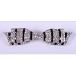 A white metal mounted pave diamond and onyx brooch, in the shape of a bow, 2" wide approx