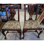 A pair of Georgian provincial standard dining chairs with pierced vase splats and drop in seats,