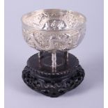 A 19th century Chinese export silver bowl with embossed decoration of two dragons amongst clouds, on
