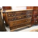 A bachelor's Georgian mahogany chest of four long graduated drawers with brass bail handles and