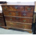 A Georgian walnut and line inlaid chest of three short and three long graduated drawers with brass