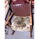 A 1930s polished as walnut low rocking chair with leather back and seat upholstered in a floral