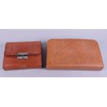 Two leather cased travelling vanity sets