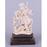 A 19th century Dieppe carved ivory figure, George and the dragon, on wooden plinth base, 7" high