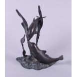An anodised brass model of two dolphins, 8" high