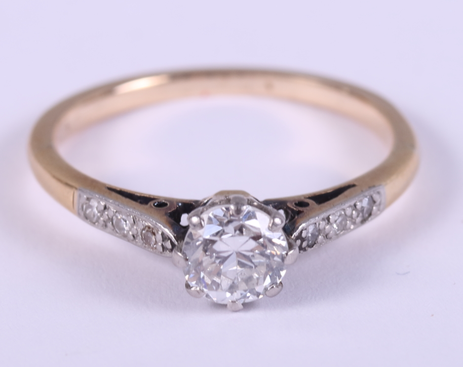 A diamond ring, central stone 0.5ct approx, the shoulders set six diamonds, 0.1ct approx, ring