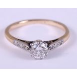 A diamond ring, central stone 0.5ct approx, the shoulders set six diamonds, 0.1ct approx, ring