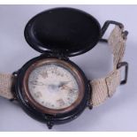 A WWII Jedburgh type Mark VI military wrist compass on AF0210 khaki webbing strap