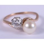 A yellow metal diamond and cultured pearl cross-over ring, ring size L/M