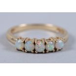 A 14ct gold five stone opal ring, size N, 2.2g (damages)