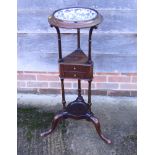 A Georgian design basin stand with black and white bowl, on tripod splay supports