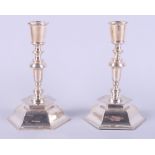 A pair of silver candlesticks, on weighted octagonal bases, 7" high