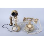 An early 20th century onyx rotary dial telephone and a brass framed telephone