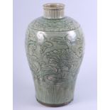 A Chinese celadon glazed vase with carved foliage decoration, 13" high