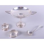 An early 20th century silver trophy cup, two silver napkin rings and a sauce ladle, 5.1oz troy