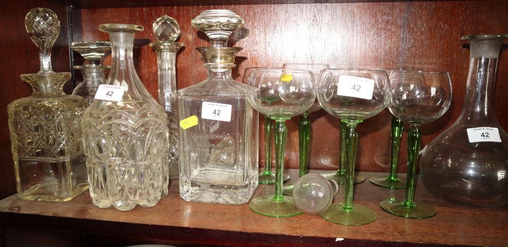 Four cut glass decanters, one with silver mount, and one other decanter