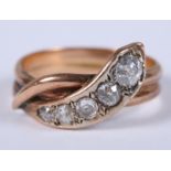 A Victorian yellow metal ring set five graduated diamonds, formed as a snake, ring size S, 6g gross