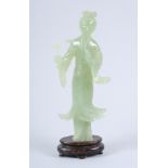 A Chinese carved jade figure of Kuan Yin, on carved wood base, 8" high overall (damages)