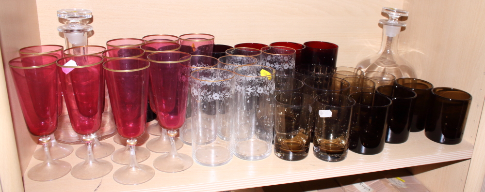 Eight cut glass sundae dishes, eleven cranberry glass champagne flutes and various other drinking