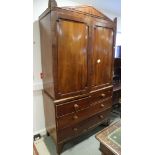 A mid 19th century mahogany Empire design linen press, the upper section with pediment and acroteria