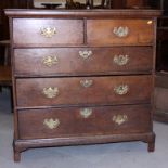 An early 18th century oak chest of two short and three long graduated drawers, on bracket feet,