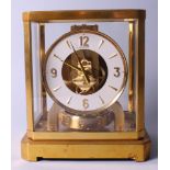 A Jaeger-LeCoultre Atmos clock in brass and glass case, 9 1/4" high