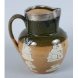 A Doulton Lambeth water jug, decorated in high relief with bucolic scenes, silver mounts for 1899,