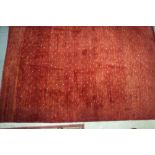 A modern abstract design rug with squares and dots on a red ground, 107" x 79" approx